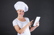 © Wisiel - cooking, technology and food concept - smiling female chef, cook