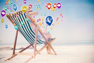 Aufkleber - Woman in sunhat sitting on beach in deck chair