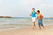 © kraevski - Mother with her son are running on the beach and having fun