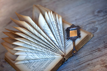 Decorating with an old folded book and a miniature mirror