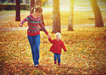 Wall Mural - happy family mother and child little daughter on autumn walk