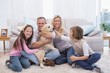 © WavebreakmediaMicro - Smiling family with their pet yellow labrador on the rug