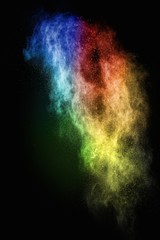Wall Mural - colourful powder exploding isolated on black