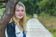© benschonewille - Portrait of blonde girl with trunk and path in nature