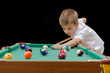 Beautiful boy playing billiard (pool)