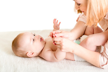 Wall Mural - mother massaging or playing with her baby