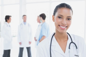 Wall Mural - Smiling doctor looking at camera