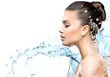Leinwandbild Motiv Beautiful model woman with splashes of water in her hands