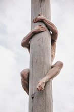 Man Climbing  On  Post Pole