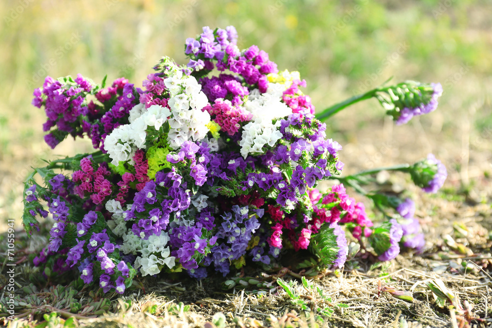 Beautiful bouquet of wildflowers on grass