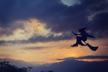 Silhouette Of Witch Flying On Broomstick At Dramatic Sky