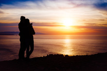 Couple Looking The Sunset And Ocean