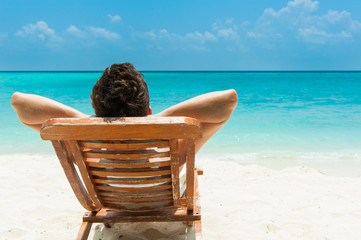 Young man resting on beach