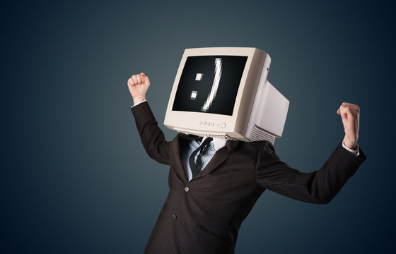 Funny young businessman with a monitor on his head and smiley on