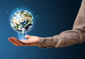 Wall Mural - Businessman holding a glowing earth globe