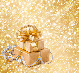 Gift box in gold wrapping paper on a beautiful abstract backgrou