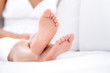 Woman feet closeup - barefoot woman relaxing sofa