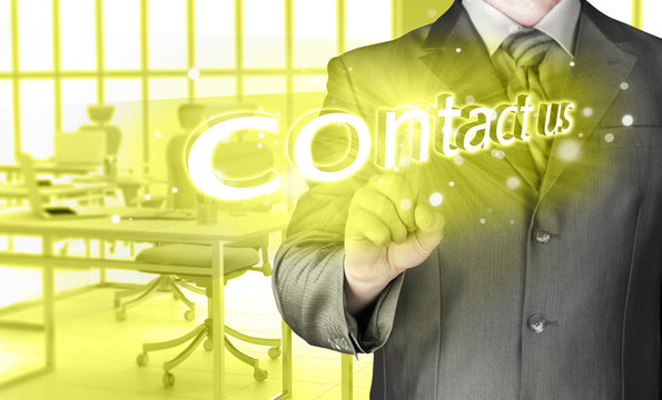 Businessman pushing CONTACT US sign