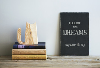 Wall Mural - motivational quote FOLLOW YOUR DREAMS on chalkboard with books
