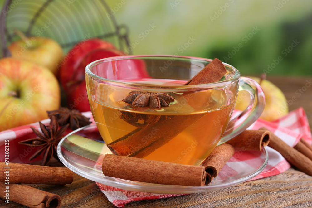 Apple cider with cinnamon sticks and fresh apples