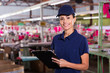 © michaeljung - female clothing factory worker with clipboard