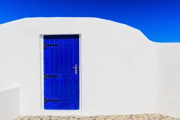 Wall Mural - Blue door & white wall, Santorini Greece