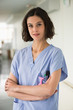 © onoky - Portrait of a female nurse standing with her arms crossed