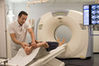 © onoky - Male doctor preparing patient for MRI scan in hospital