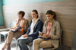 © onoky - Three women in waiting area of hospital