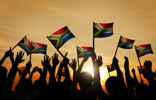 Group Of People Waving South African Flags In Back Lit