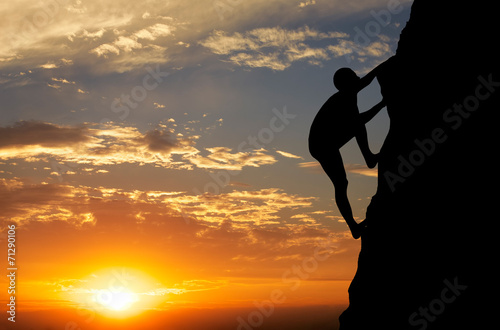 Plakat na zamówienie Rock climber at sunset background. Sport and active life