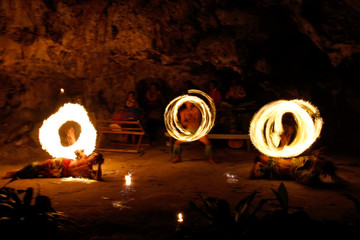 Fire show in famous Hina cave, blurred motion, Oholei beach, Ton