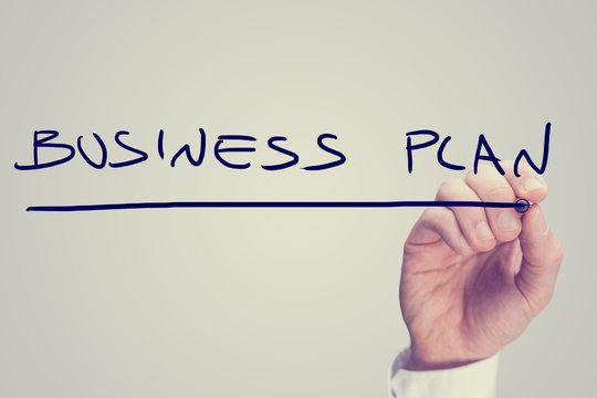 Hand writing business plan on a virtual screen