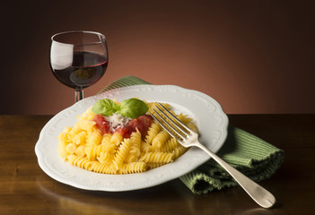 Wall Mural - dish with macaroni and tomato sauce on the wooden table