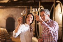 Couple Tasting A Glass Of White Wine In A Traditional Cellar Sur