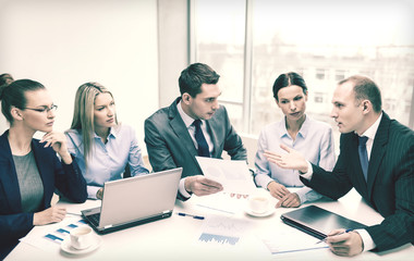 Poster - business team with laptop having discussion