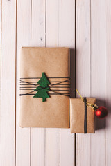 Christmas handcraft gift boxes on wood background.