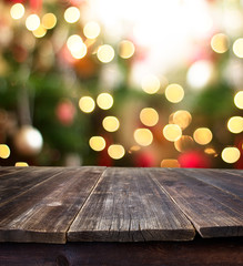 empty rustic table over christmas bokeh