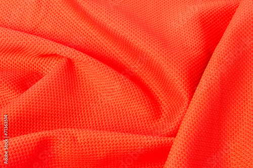 Fotografija texture of bright, acid orange cloth with pleats