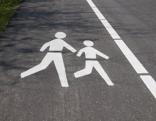 Pedestrian logo on tarmac