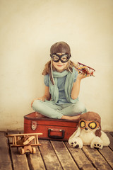 Poster - Happy child playing with toy airplane