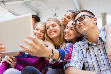 Canvas Print - group of smiling students with tablet pc