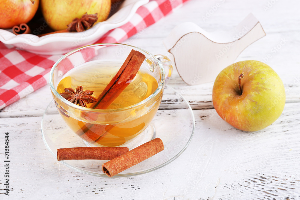 Apple cider with cinnamon sticks and fresh apples