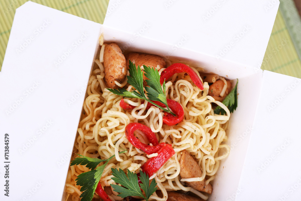 Chinese noodles in takeaway box closeup