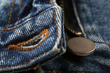 Zipper and button on clothes close up