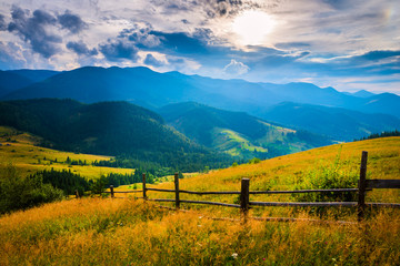 Wall Mural - amazing mountain landscape with fog and a haystack