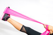 Woman stretches with resistance bands around her foot