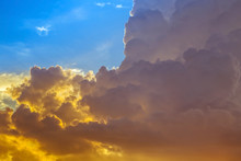 Abstract Yellow Dark Clouds On Blue Sky In Sunset