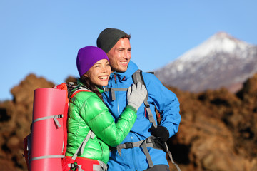 Wall Mural - Campers couple hiking enjoying looking at view