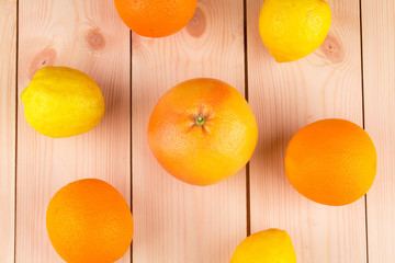 Wall Mural - Fresh oranges and lemons on wooden background